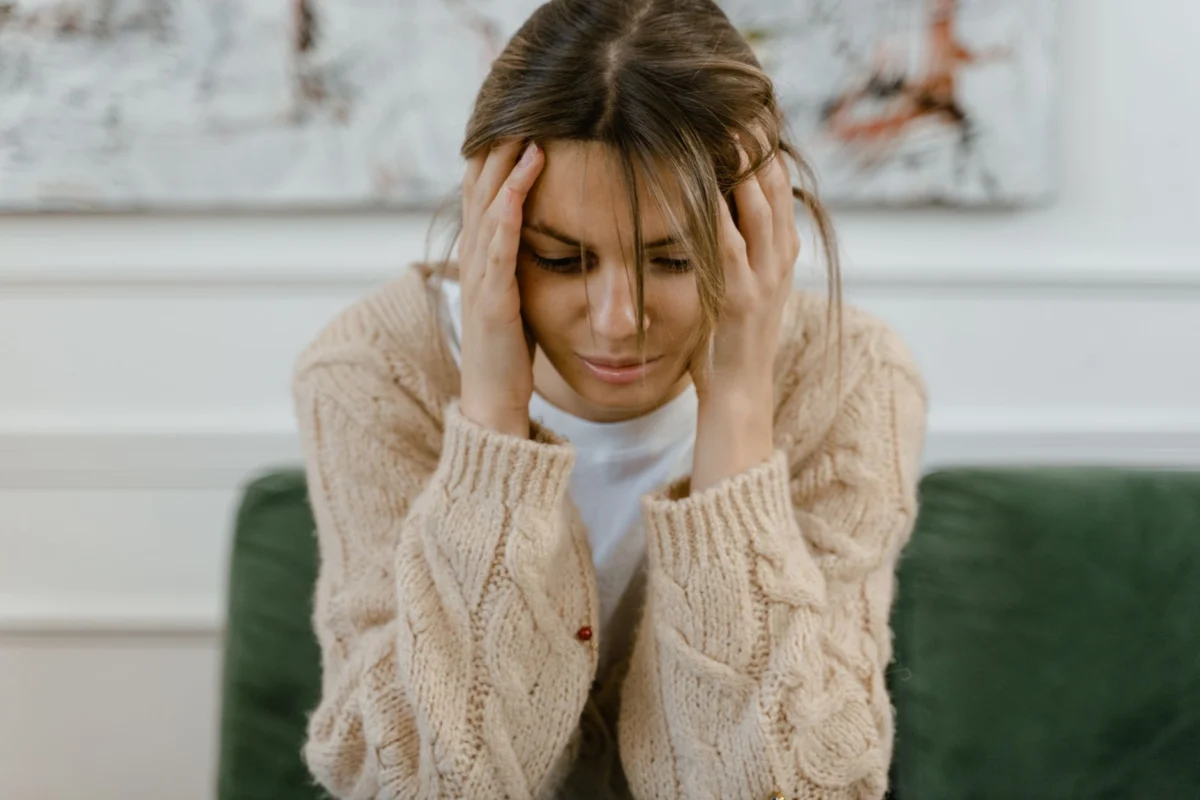 Pessoa com olhos fechados praticando respiração tranquila em ambiente acolhedor